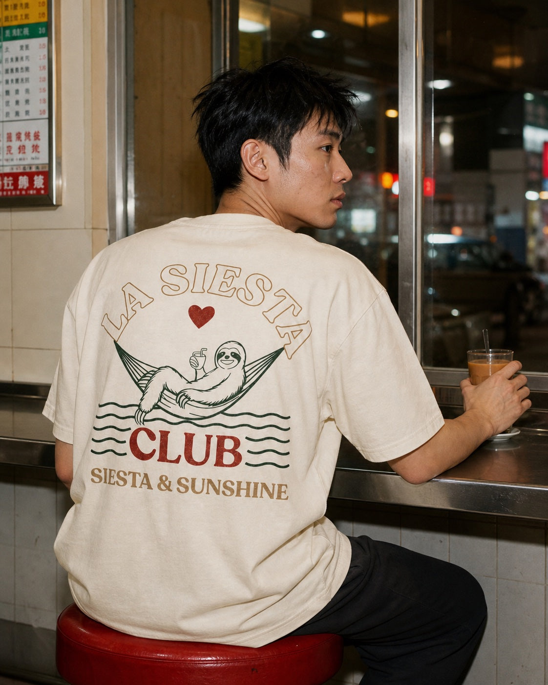 Man wearing a Zeron T-shirt at a Hong Kong cha chaan teng