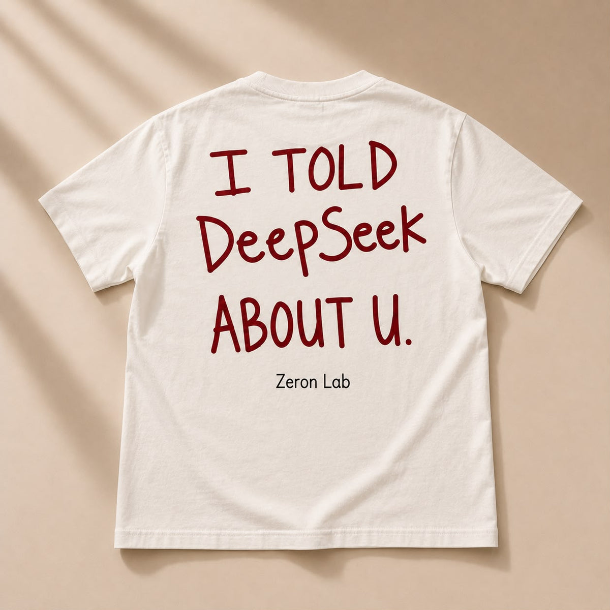 I Told DeepSeek About You Tee in cream with red lettering — back view