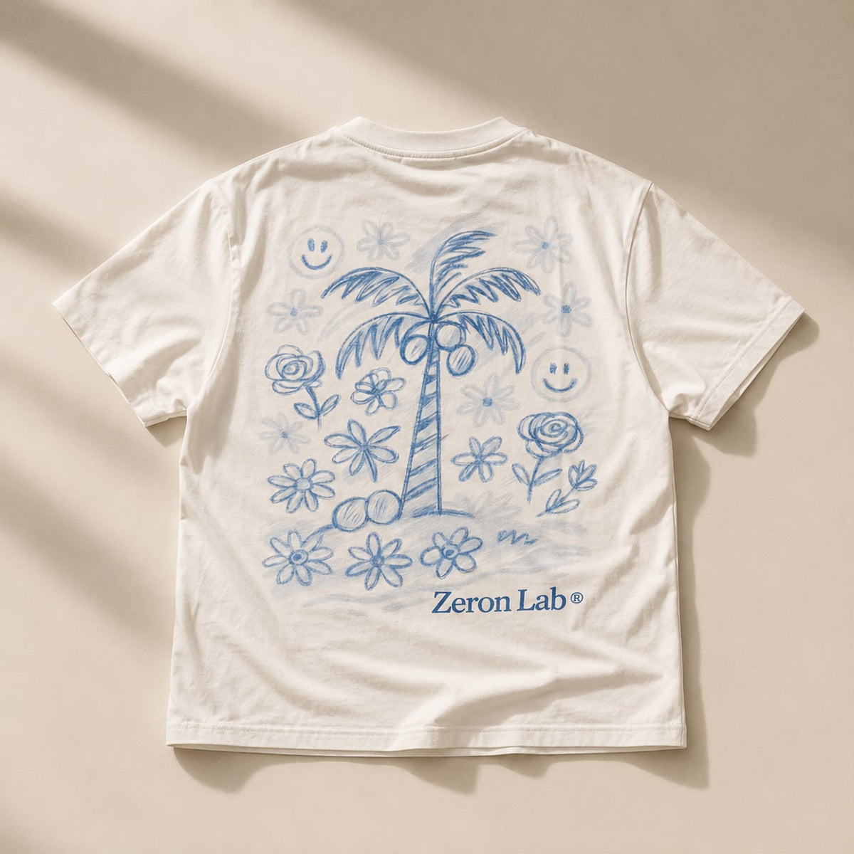 Palm Paradise Tee in cream with blue hand-drawn palm and flowers — back view